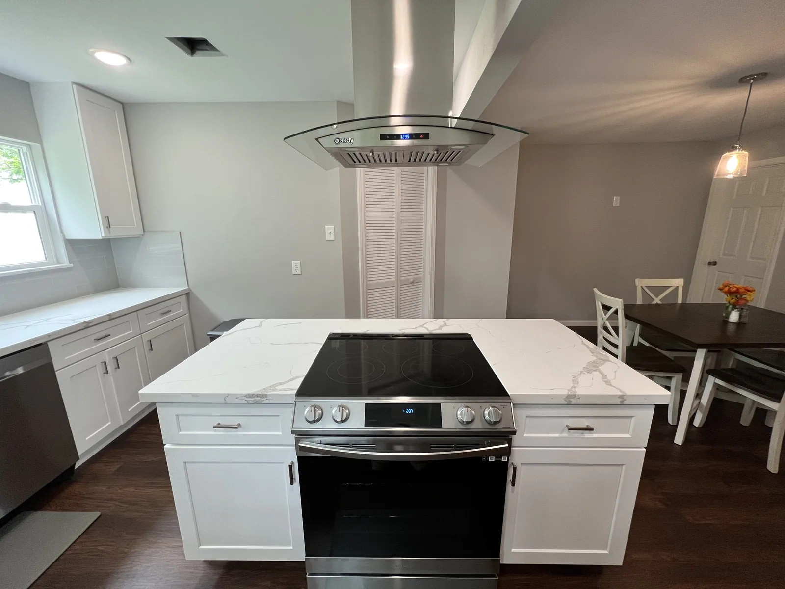 Open kitchen with a quartz island built as part of a home addition by Texan Home Additions, serving Angleton, TX