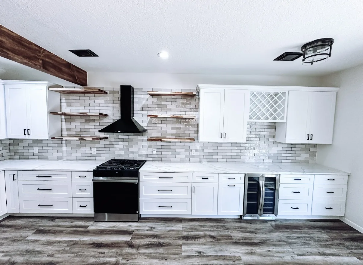 Renovated kitchen with efficient layout and modern appliances in Manvel, TX by Texan Home Additions