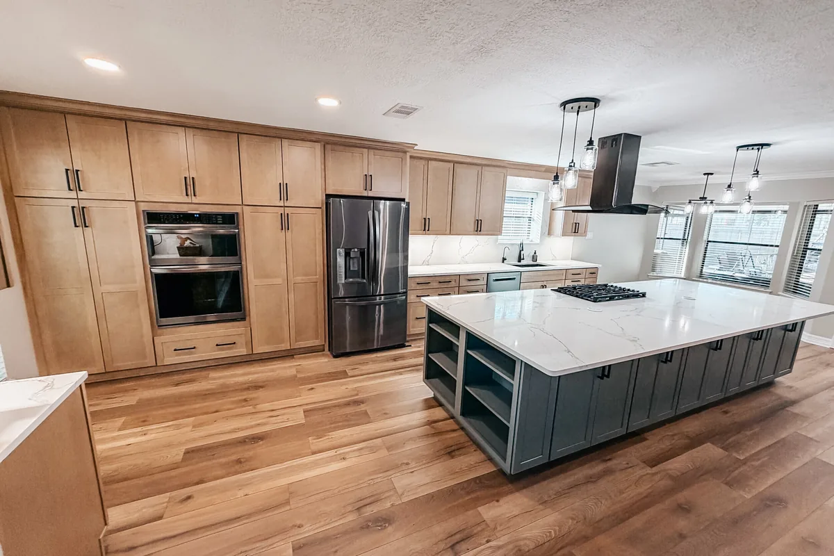 Full home remodel with an open-concept kitchen, large quartz island and wood-look floors in Pearland, TX