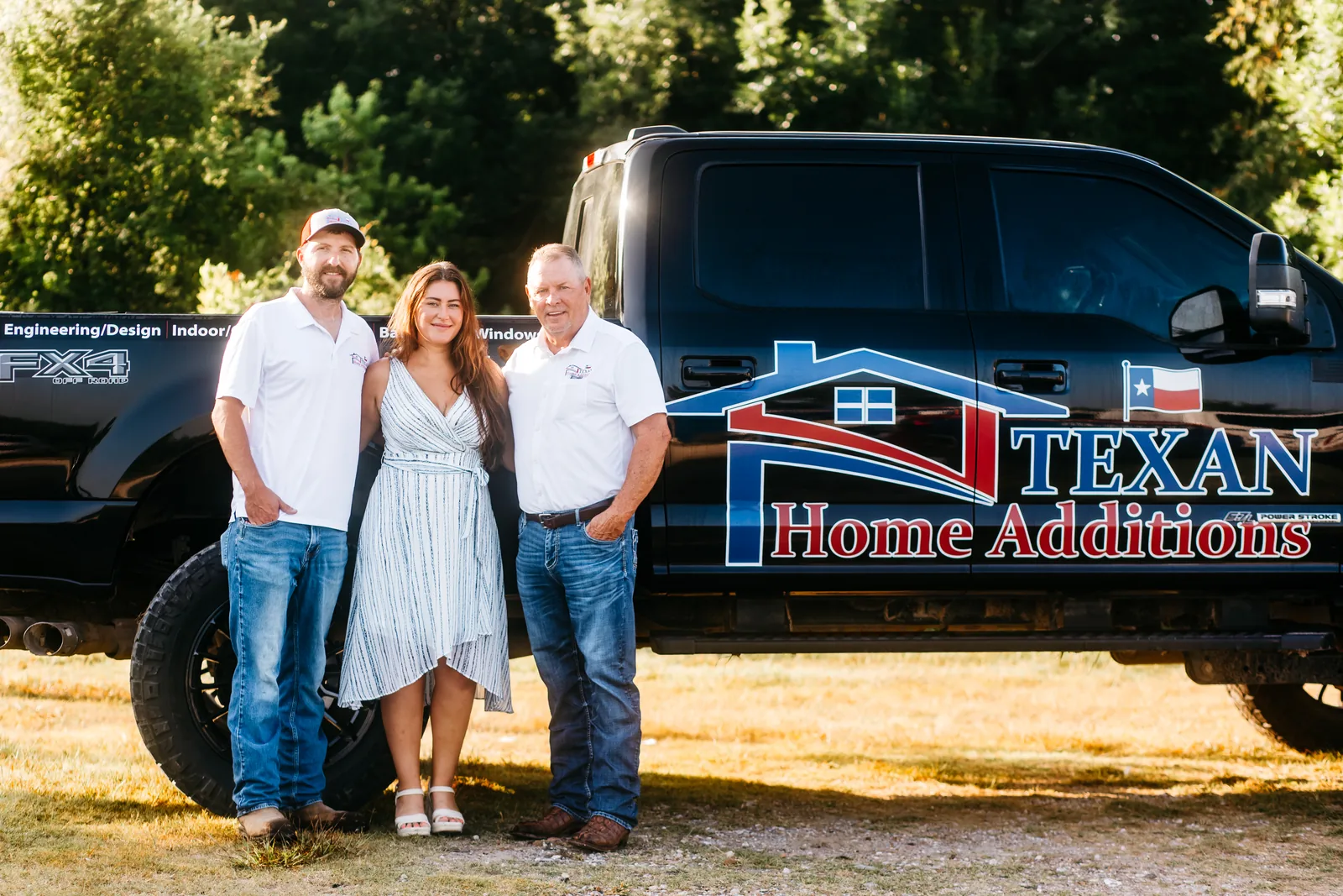 The Texan Home Additions team standing beside their branded company truck in Manvel, TX